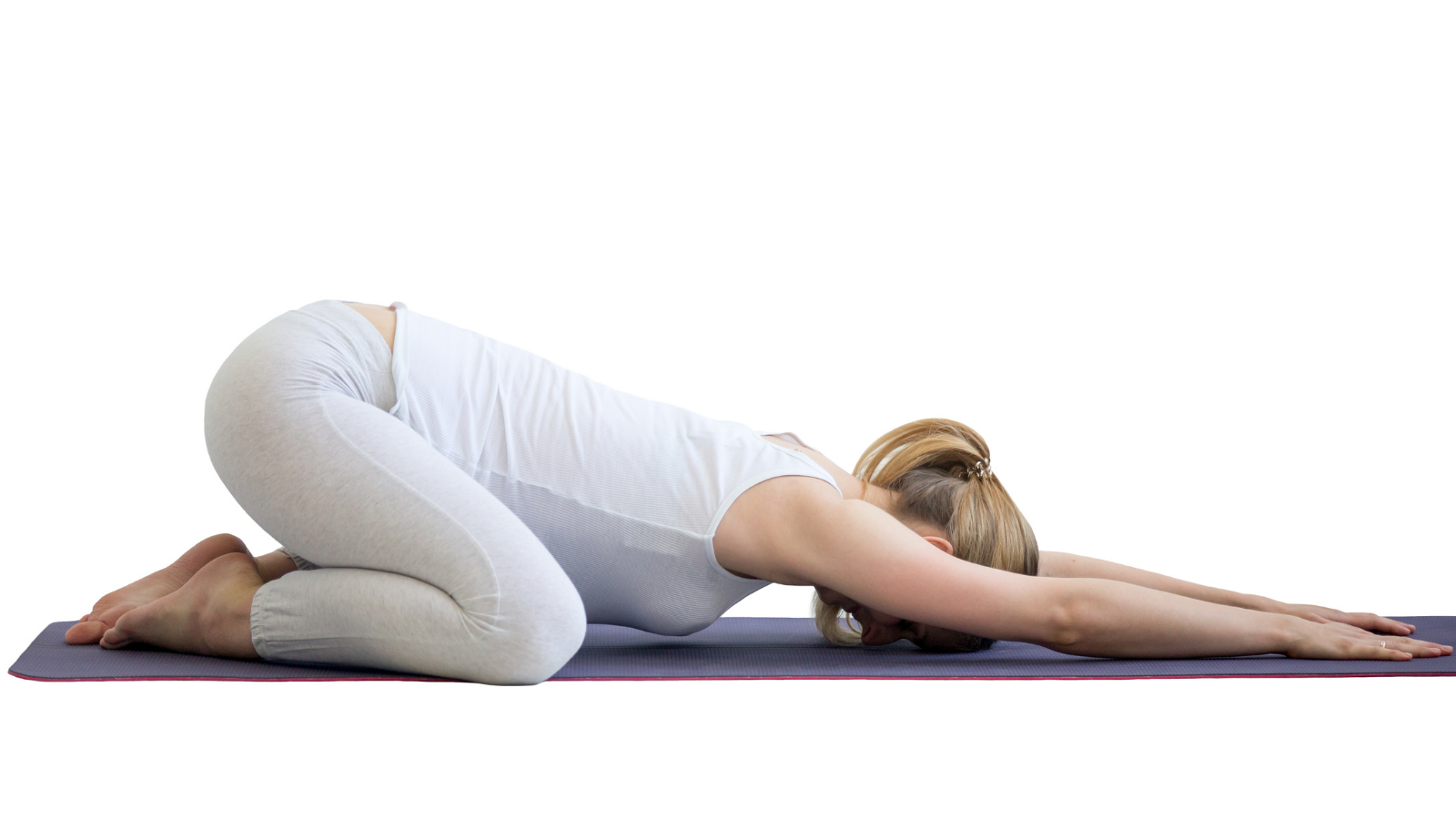 Yoga student practicing wide-knees child's pose (Balasana) with the Chakra theme of going with the flow