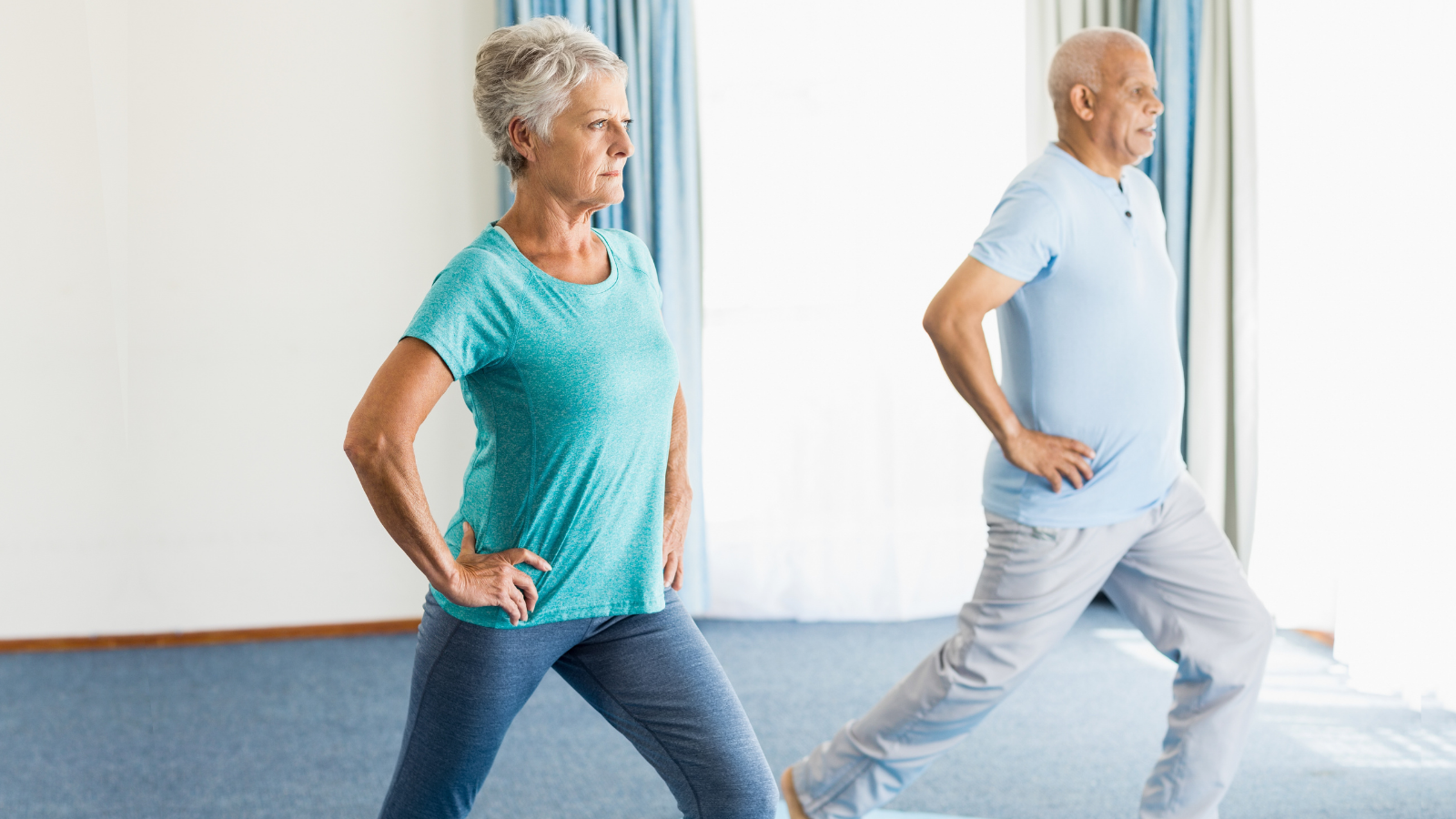 Older couple practicing yoga to improve health and lower the risks associated with Parkinson's Disease