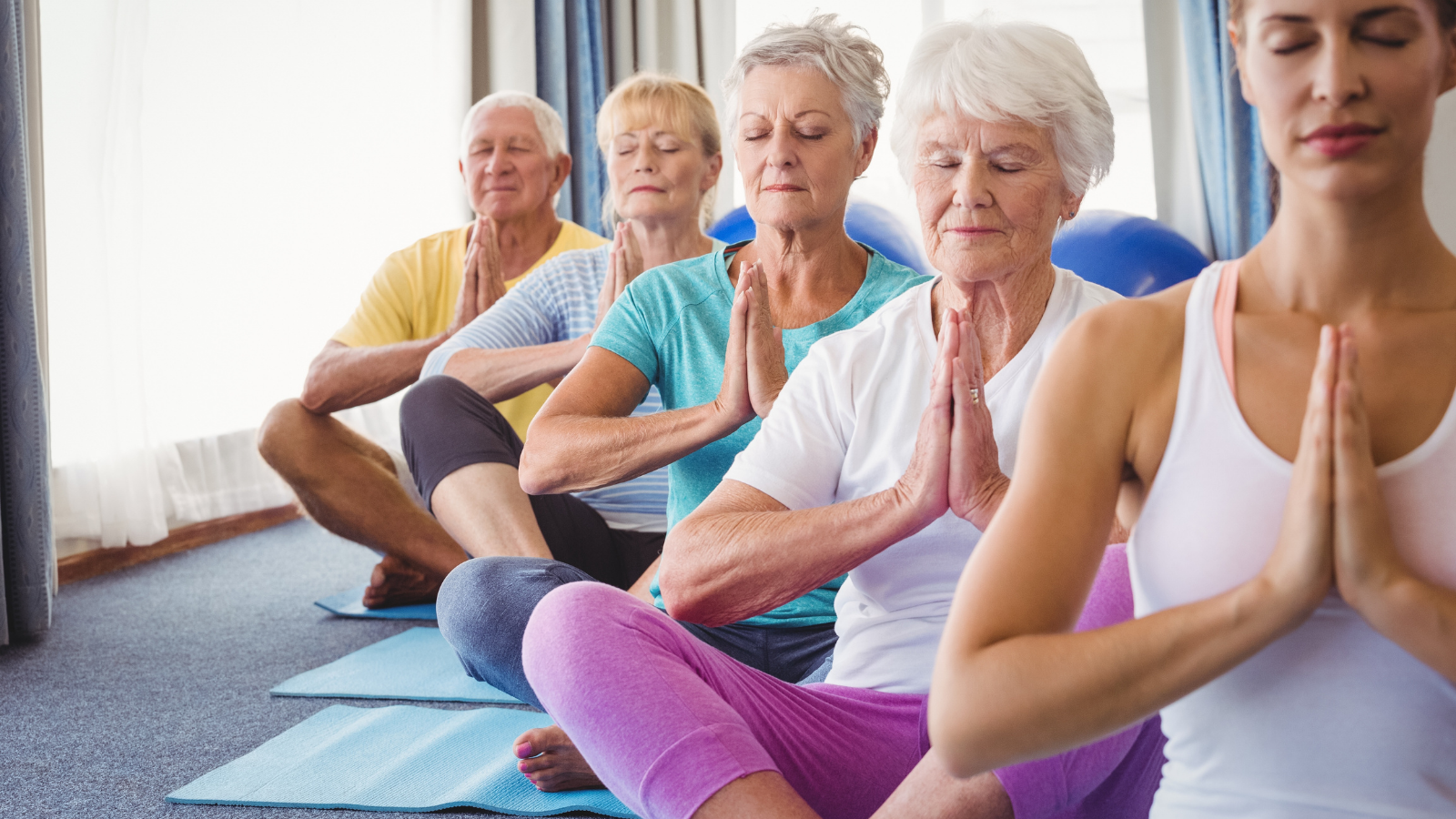 Senior mediating, doing yoga to improve motor skills, increase dopamine release for greater health