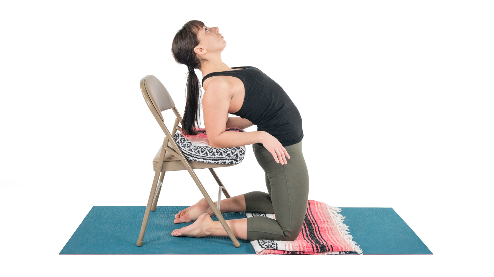 Practicing Camel Pose with the assistance of a chair and props to ease into a backbend and the opening of the heart chakra