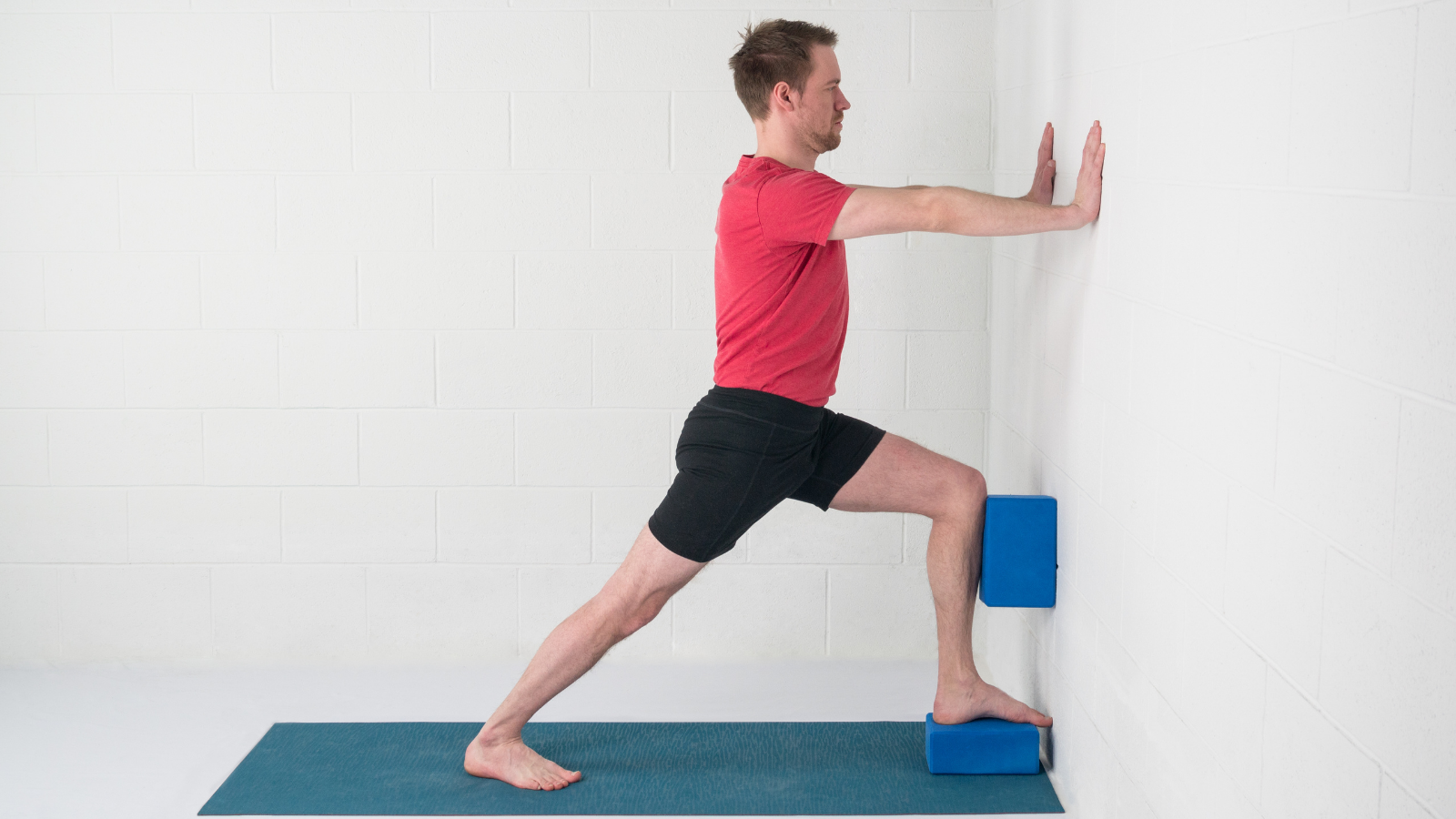 Yoga teaching tips to practice Warrior I Pose (Virabhadrasana) at the wall with block