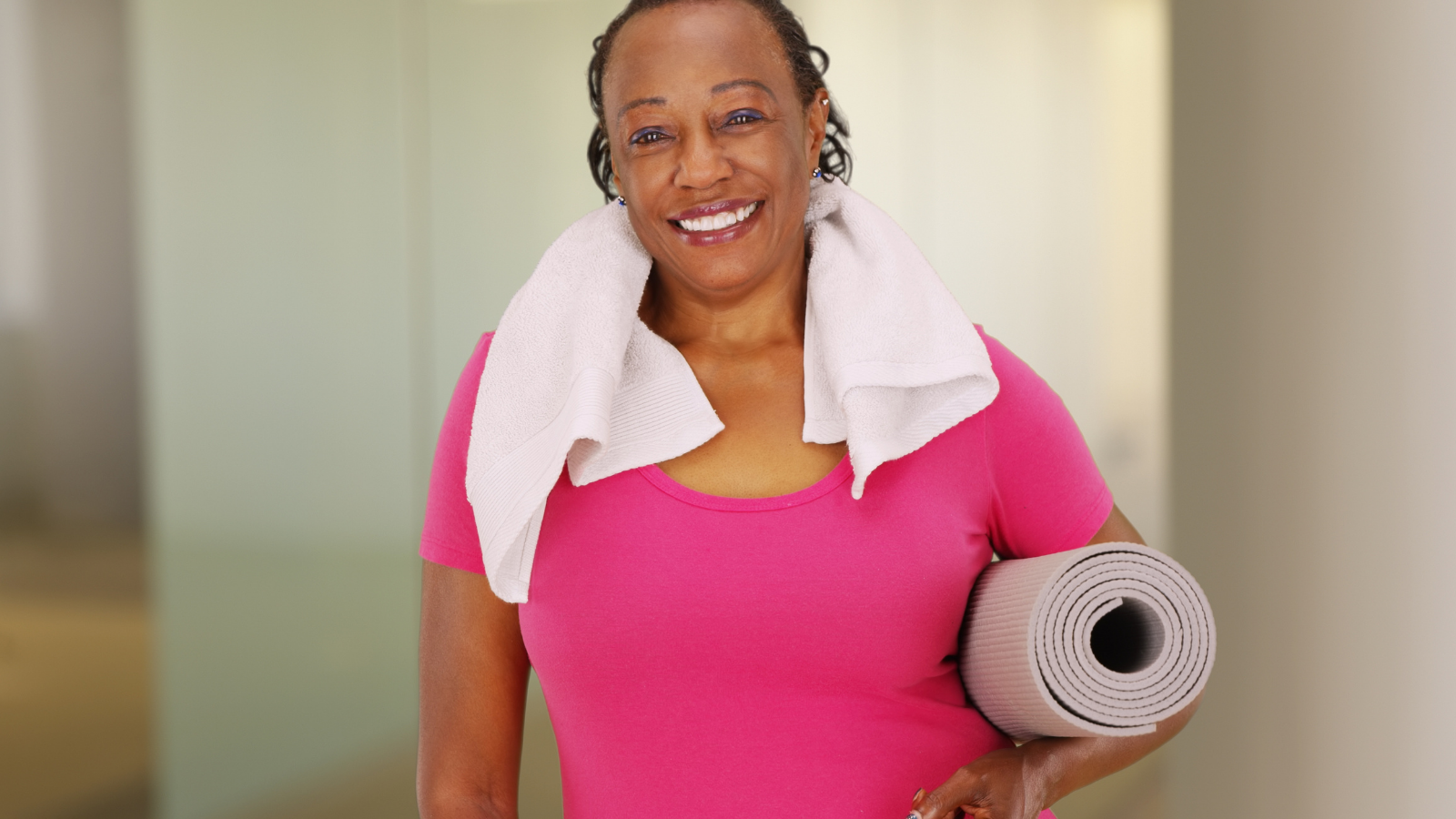 African American woman with genuine smile poses for a portrait after her workout