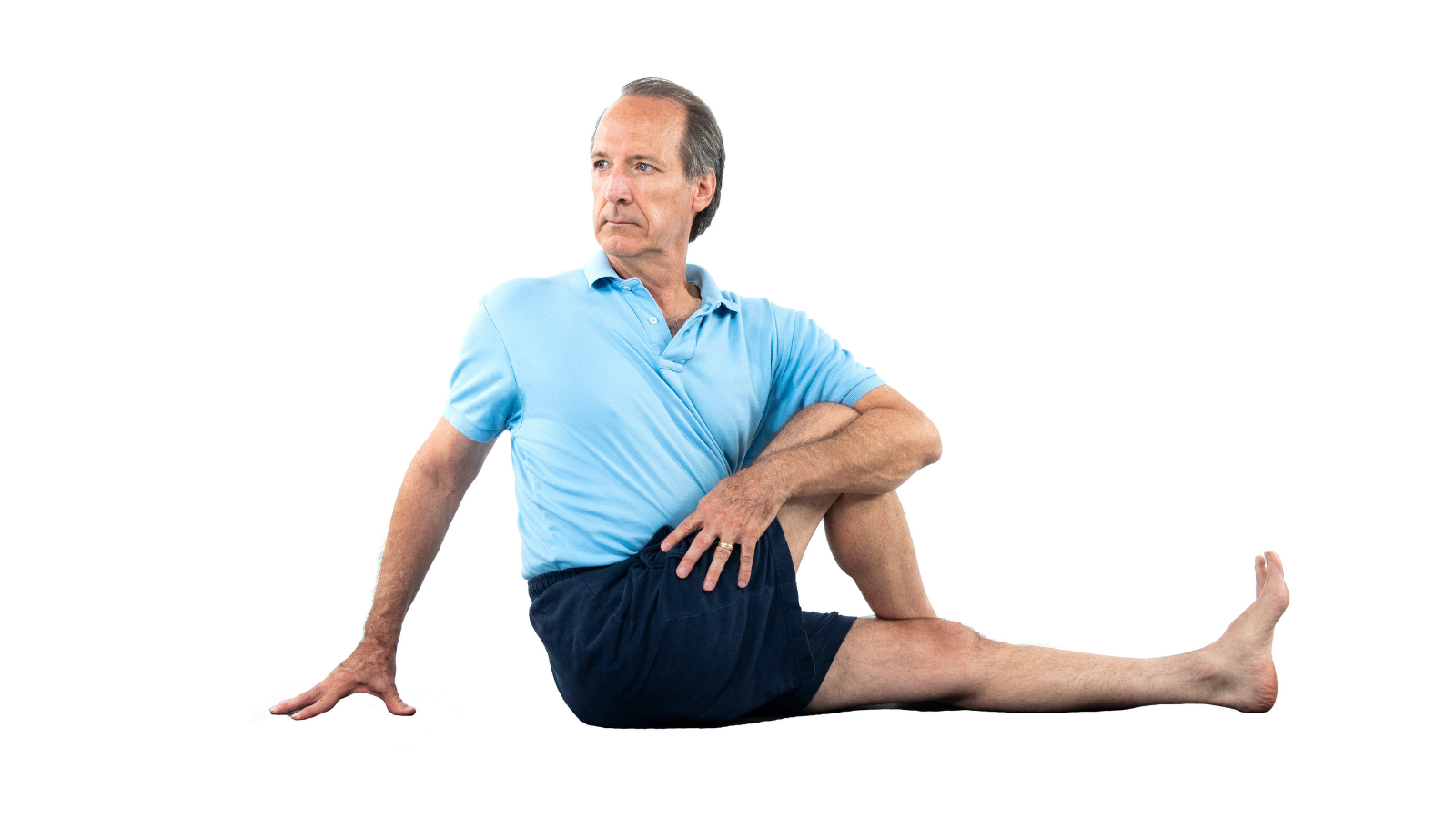 Rooting down through the legs feet, and sit bones in a seated yoga asana twist