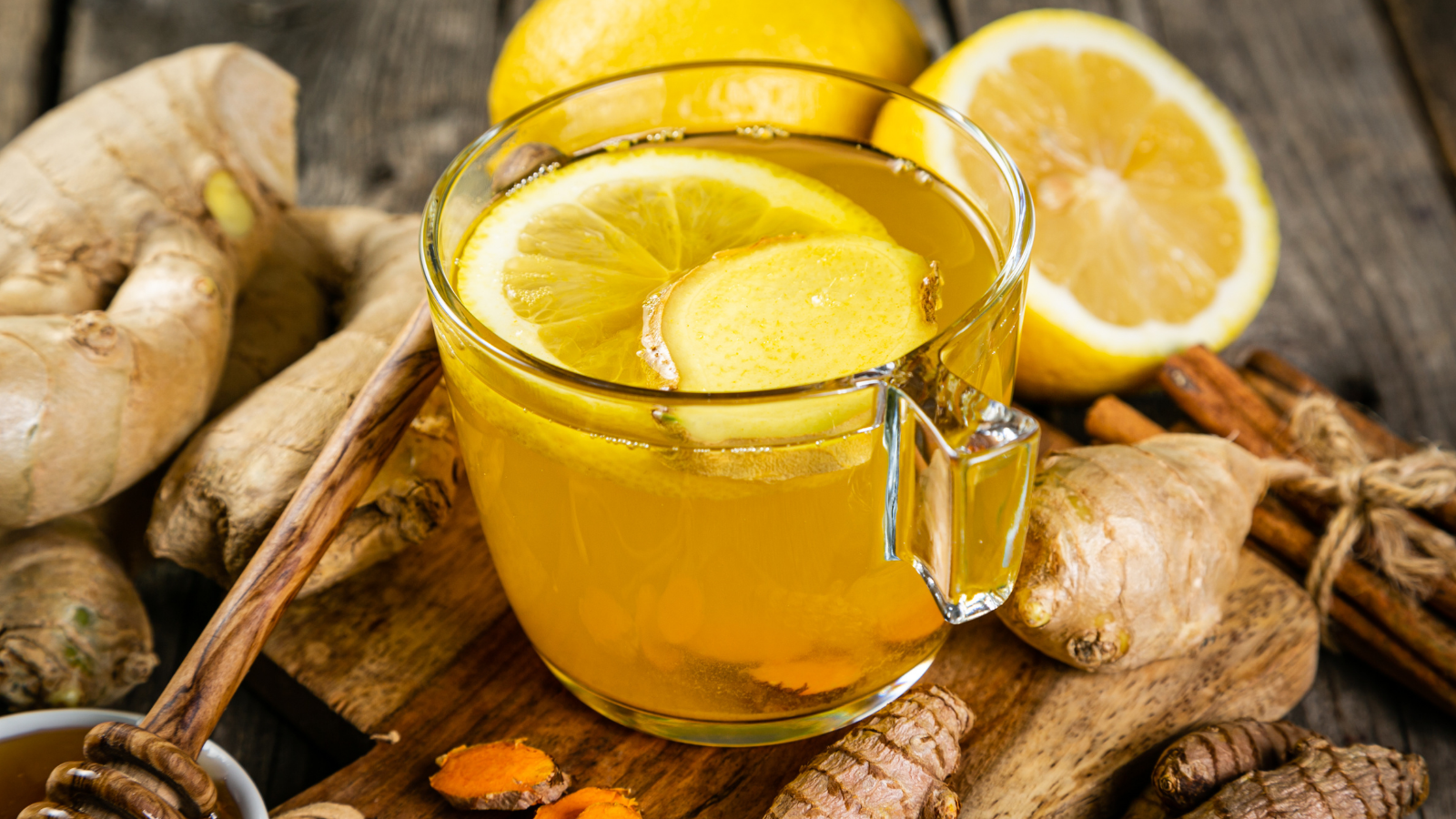 Fall immune system booster - ginger and turmeric tea and ingredients for strong immunity, rustic wood background