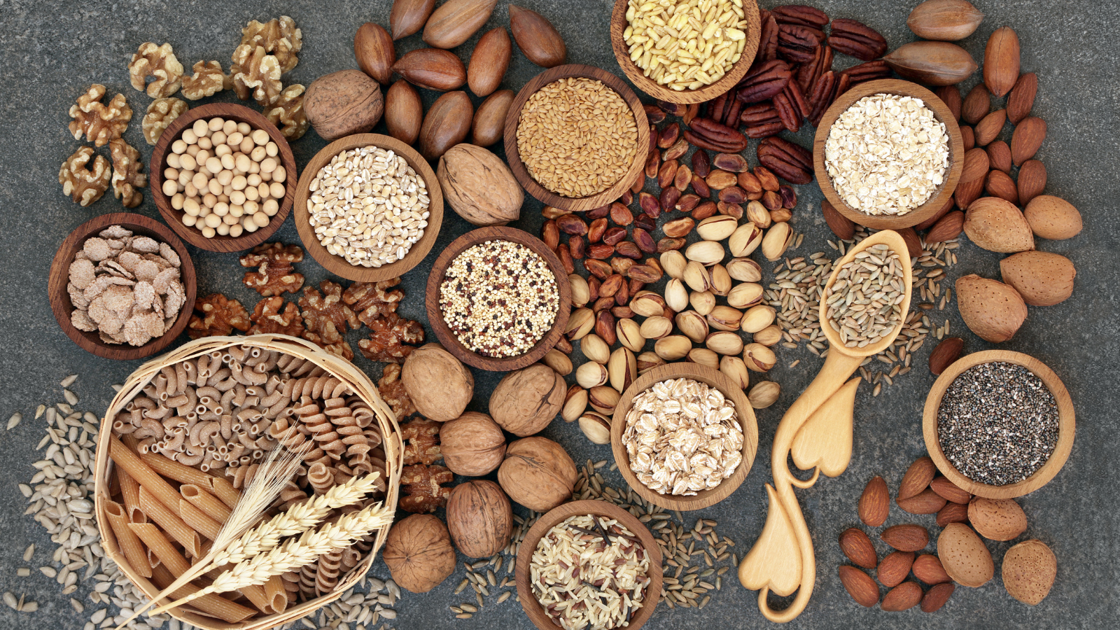 Food with high fiber content for a healthy plant-based diet with whole wheat bread, whole grain pasta, nuts, seeds, legumes, grains and cereals.