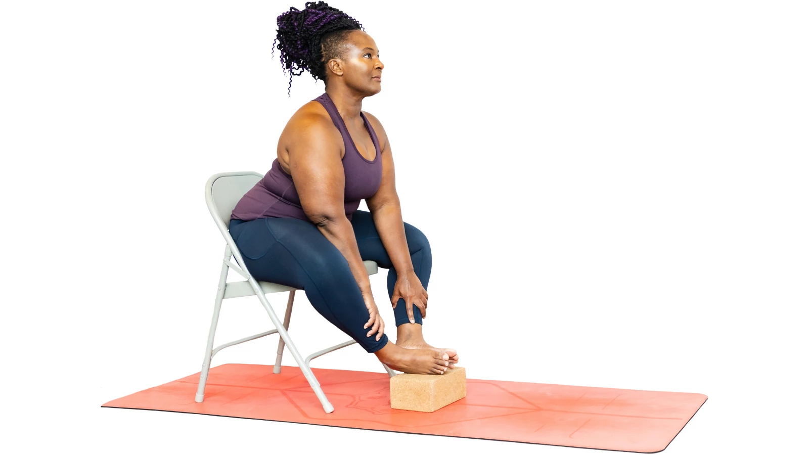 A yoga student demonstrates how to do a beginner yoga modification of Bound Angle pose (Sanskrit name: Baddha Konasana)