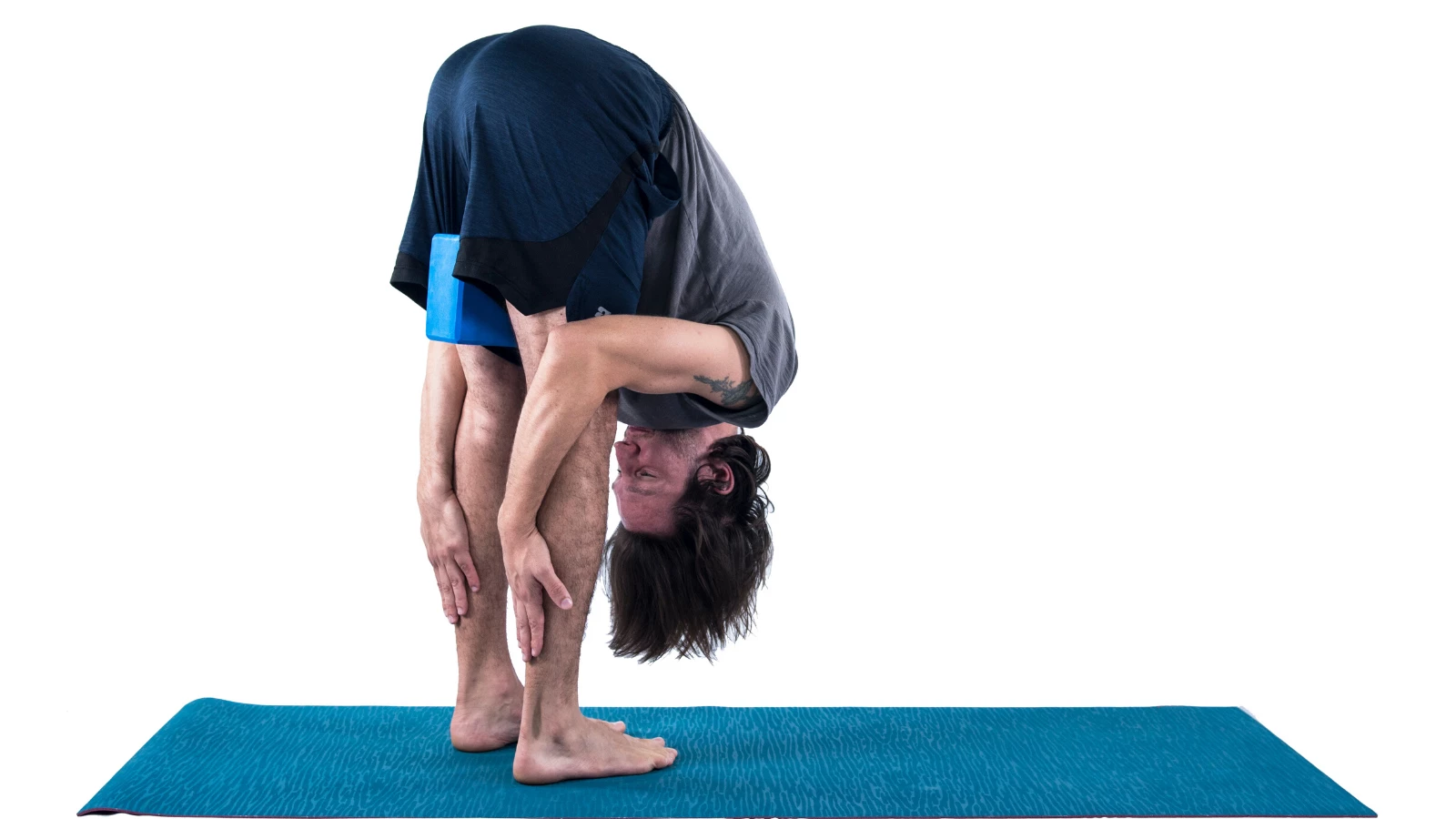 Standing Forward Bend (Uttanasana) with block between thighs