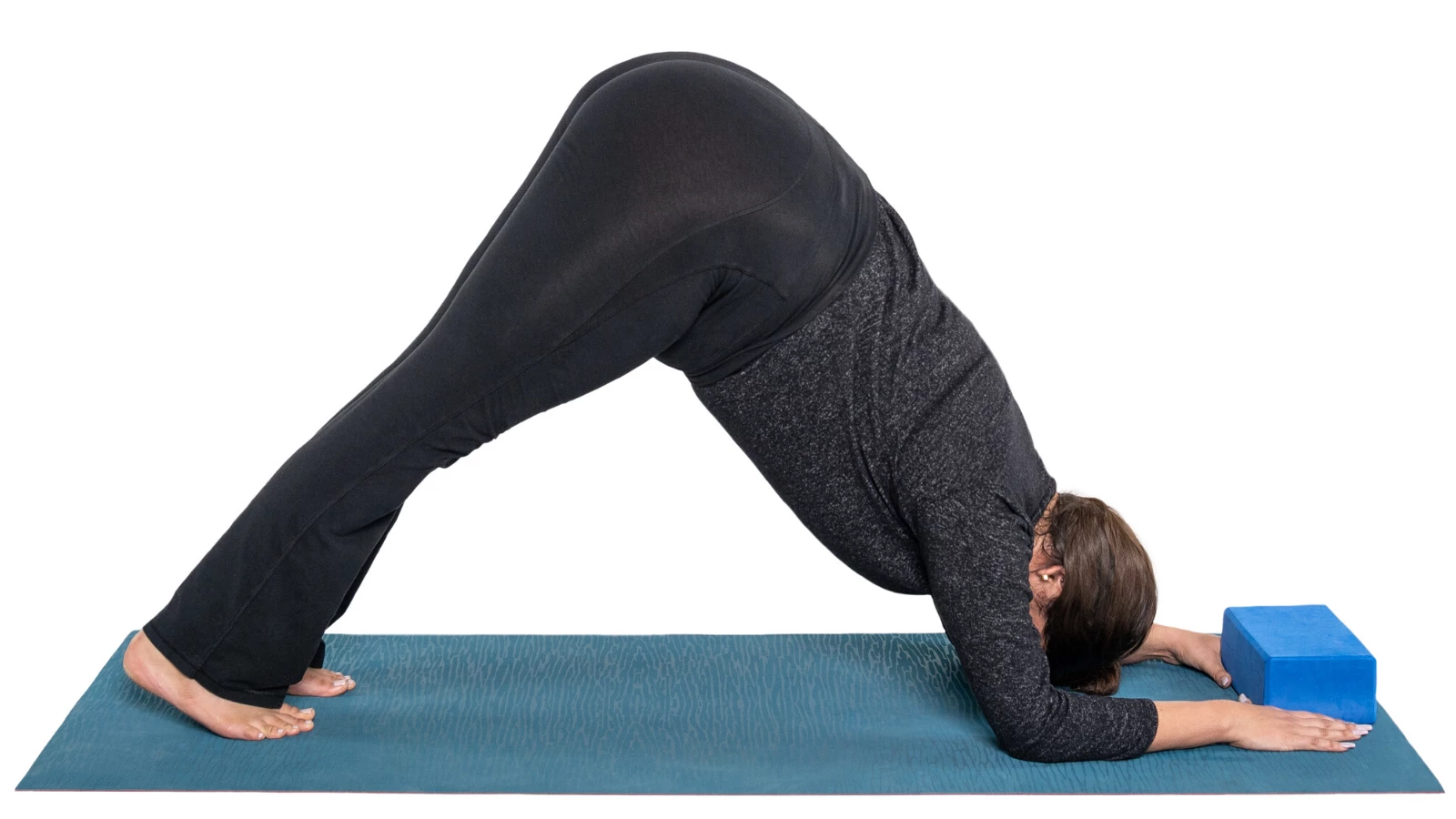 Beginner yoga student enjoys a modification of Dolphin Pose with a yoga block (Sanskrit name: Ardha Pinchamayurasana)