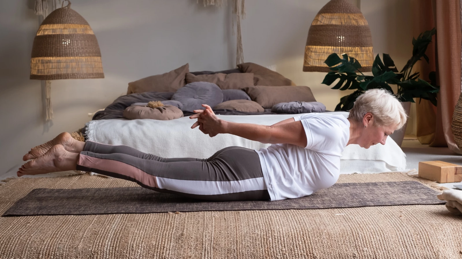 Locust Pose with arms clasped behind the back