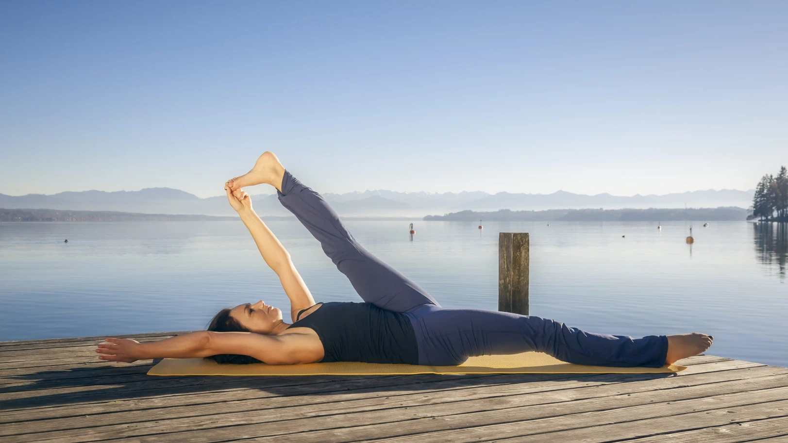 Ftiness Girl Relaxing Her Mind and Spirit in Tree Yoga Pose during