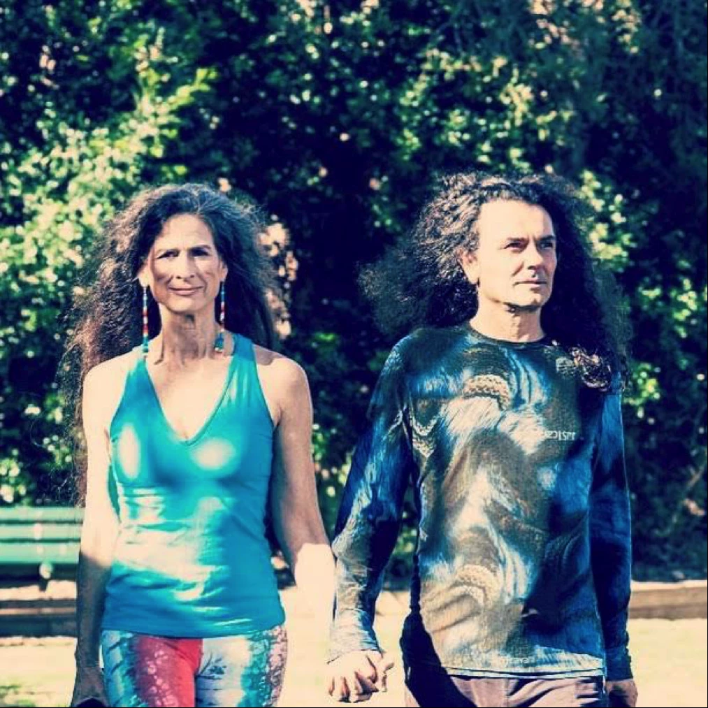 A picture of yoga teacher and medicine woman Ana Forrest, with her husband, Jose Calarco, walking and holding hands