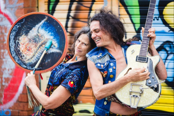 A picture of yoga teacher and medicine woman Ana Forrest, with her husband, Jose Calarco, playing musical instruments 