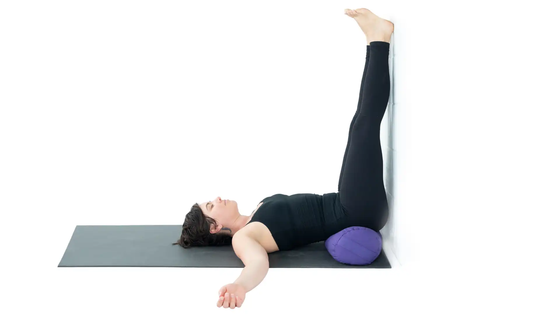 Woman practicing legs up the wall.