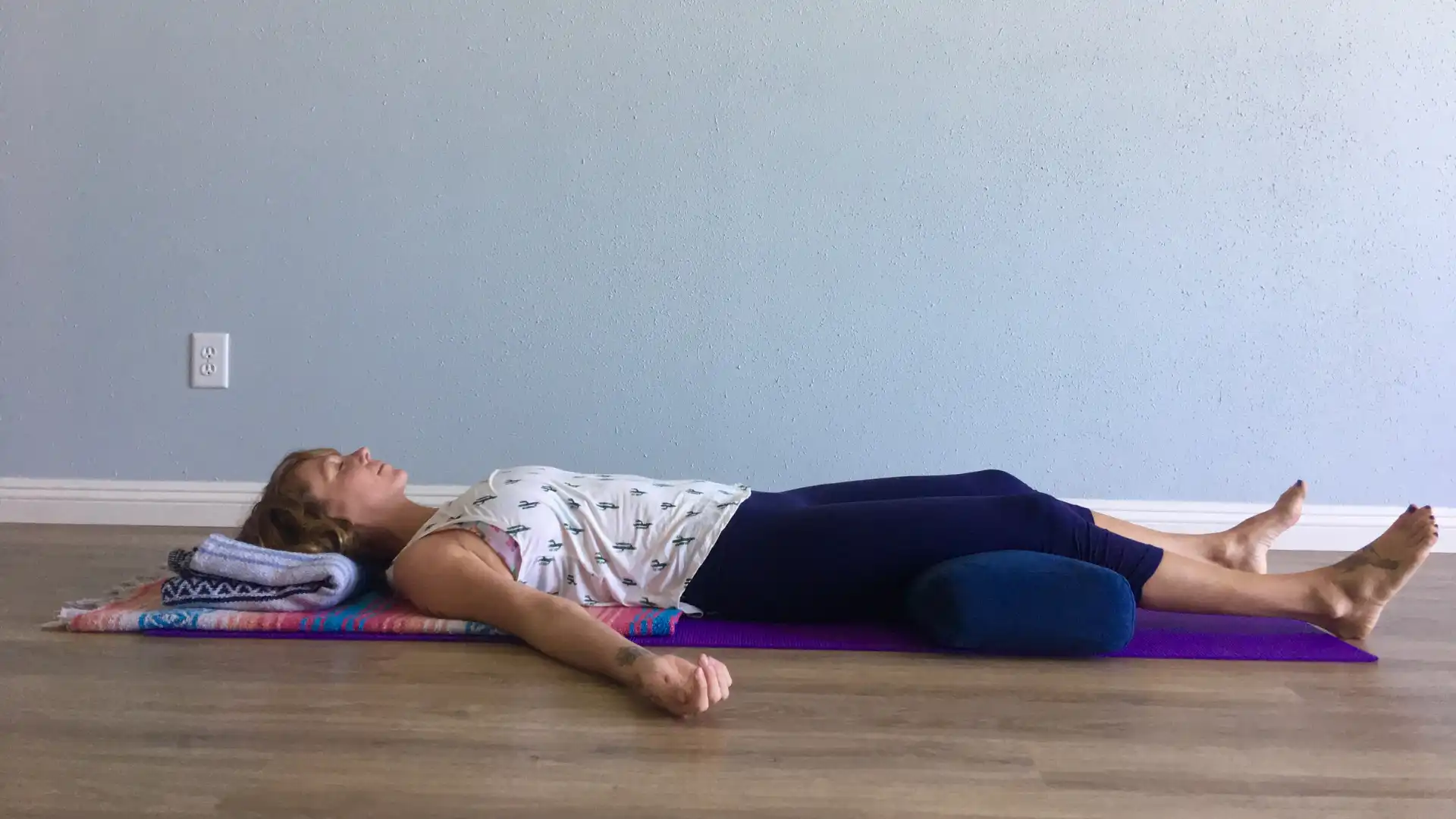 woman practicing savasana.