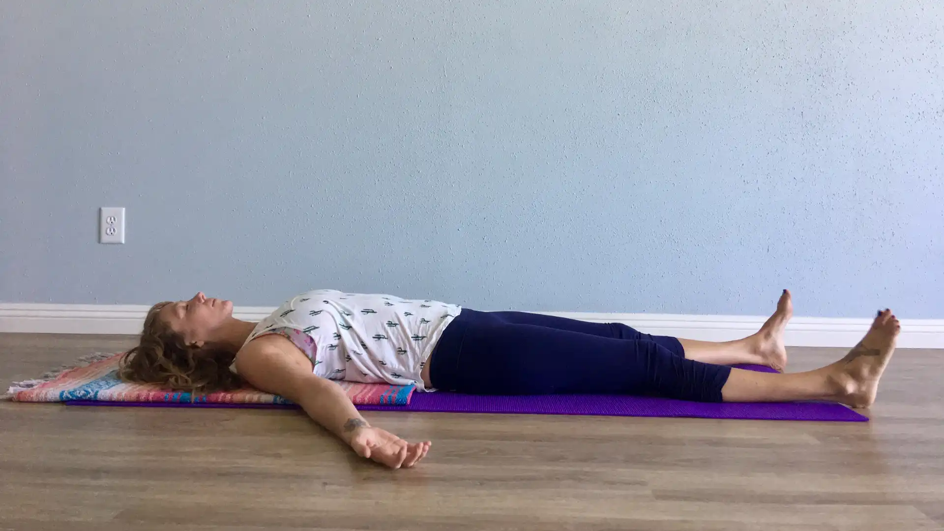 woman practicing savasana.