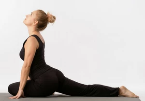 Woman in Pigeon Pose (Kapotasana), practicing awareness of body in yoga to avoid neck pain