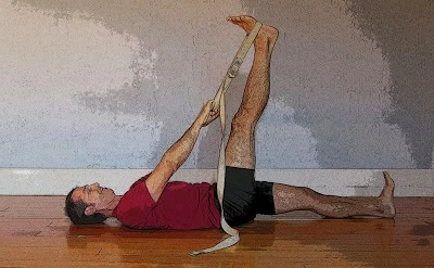 Dr. Baxter Bell practicing reclined leg stretch yoga pose (supta padangustasana) yoga for happy, healthy feet.