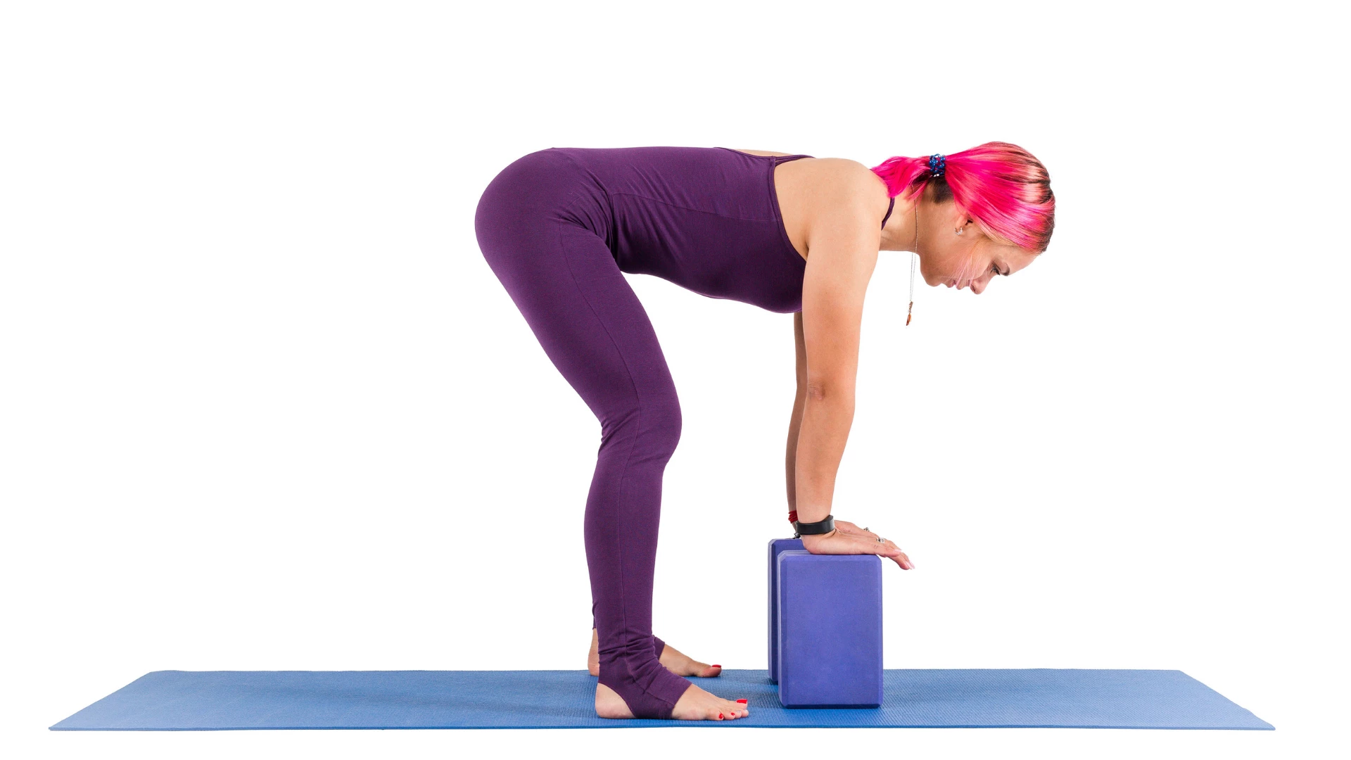 Woman practicing Uttanasana with blocks.