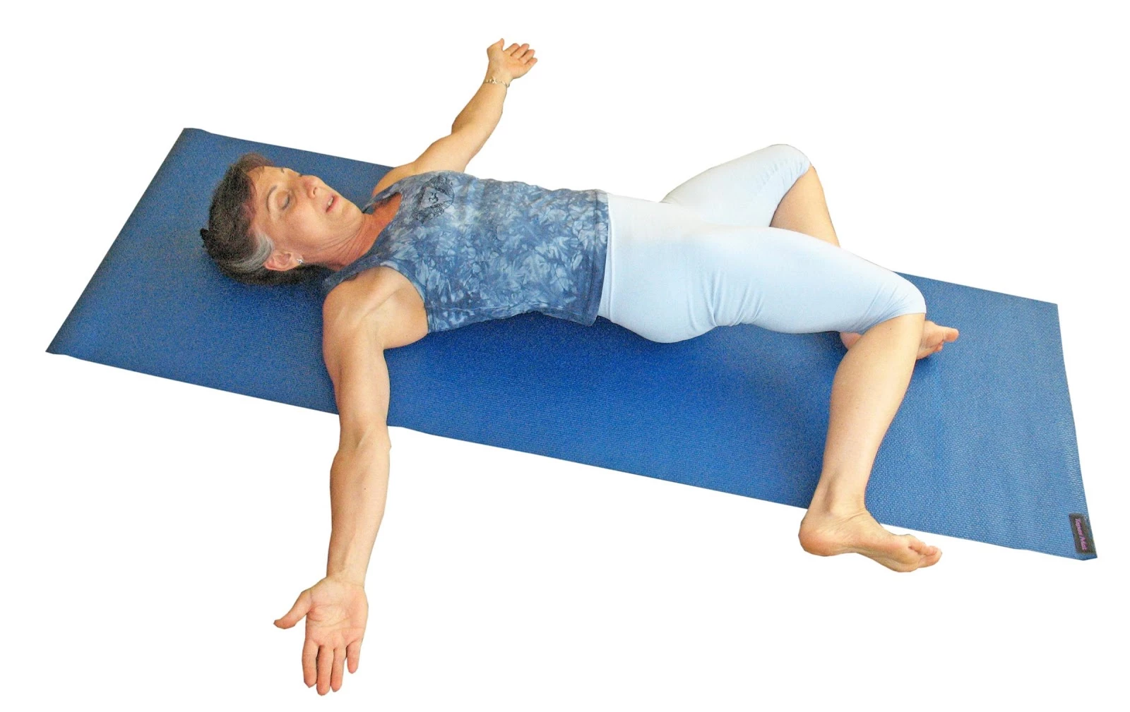 lillah schwartz practicing supine twist yoga pose as therapeutic yoga for back pain