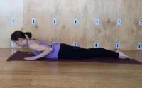 woman practicing Cobra yoga pose (bhujangasana) to relieve neck pain