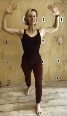 woman practicing chest opening yoga pose to relieve text neck pain