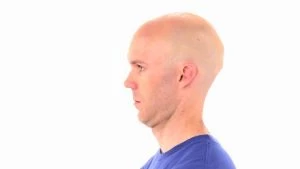 man practicing neck retraction to relieve neck pain