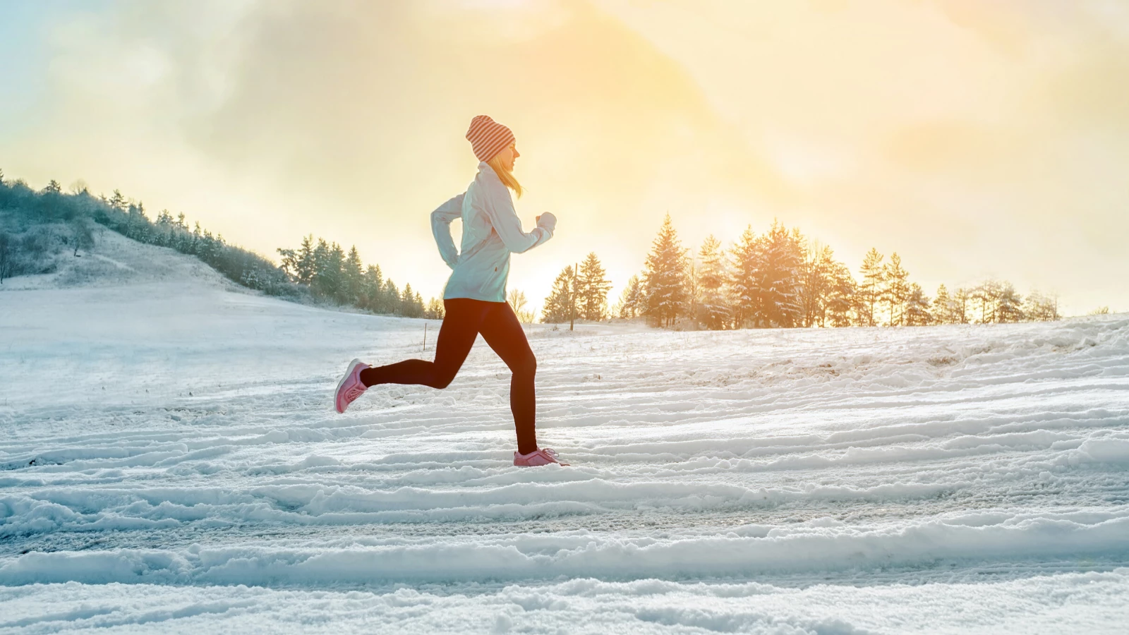 Woman running outside in the snow.