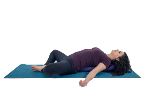 Woman practicing yoga supta baddha konasana