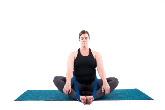 Woman practicing bound angle pose butterfly pose yoga