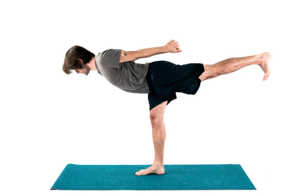 Man practicing warrior 3 yoga pose