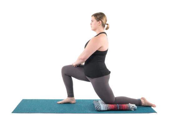 Woman practicing yoga low lunge anjanyeasana