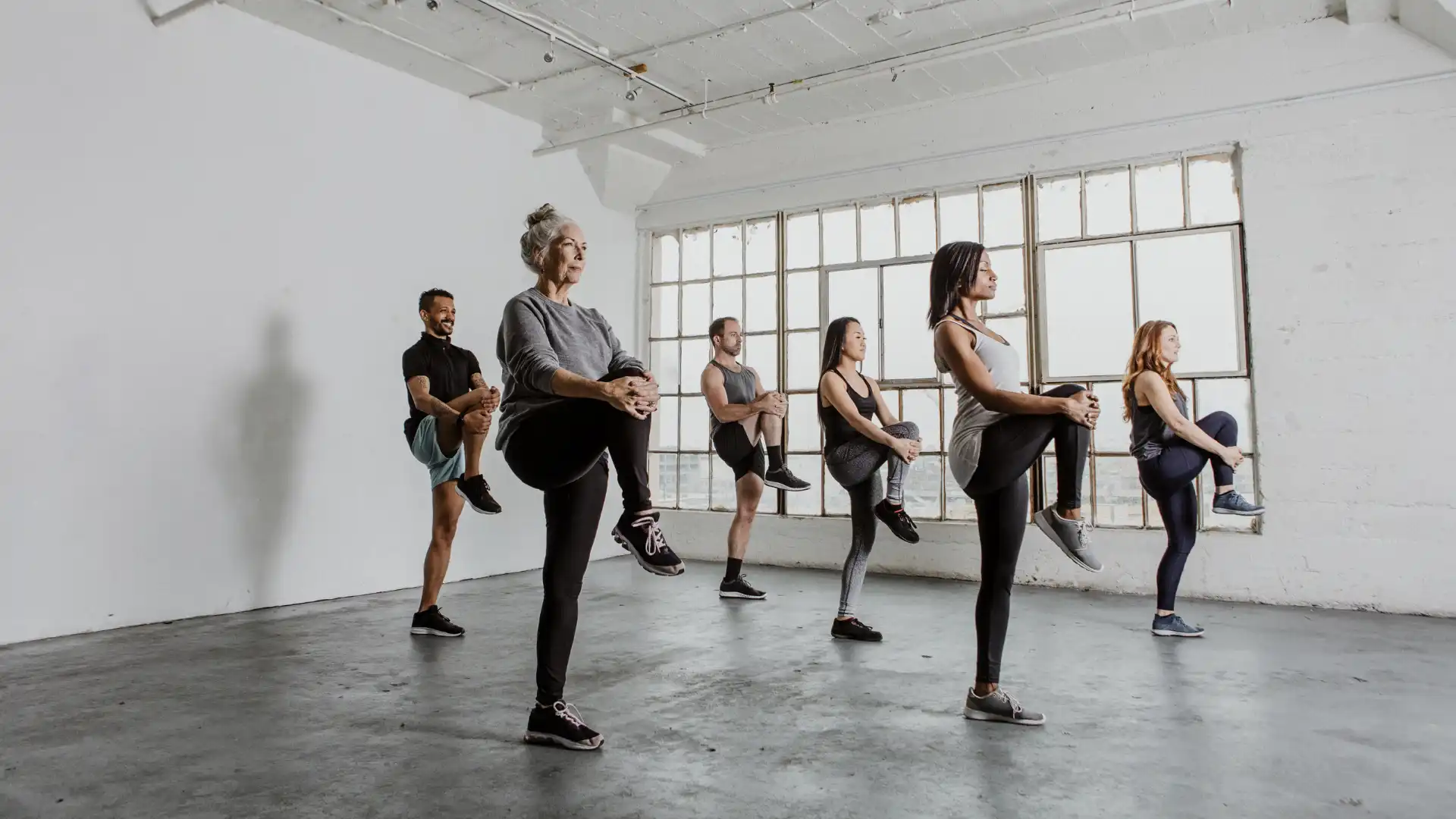 group_of_yoga_students_balancing_tadasana_mountain_pose