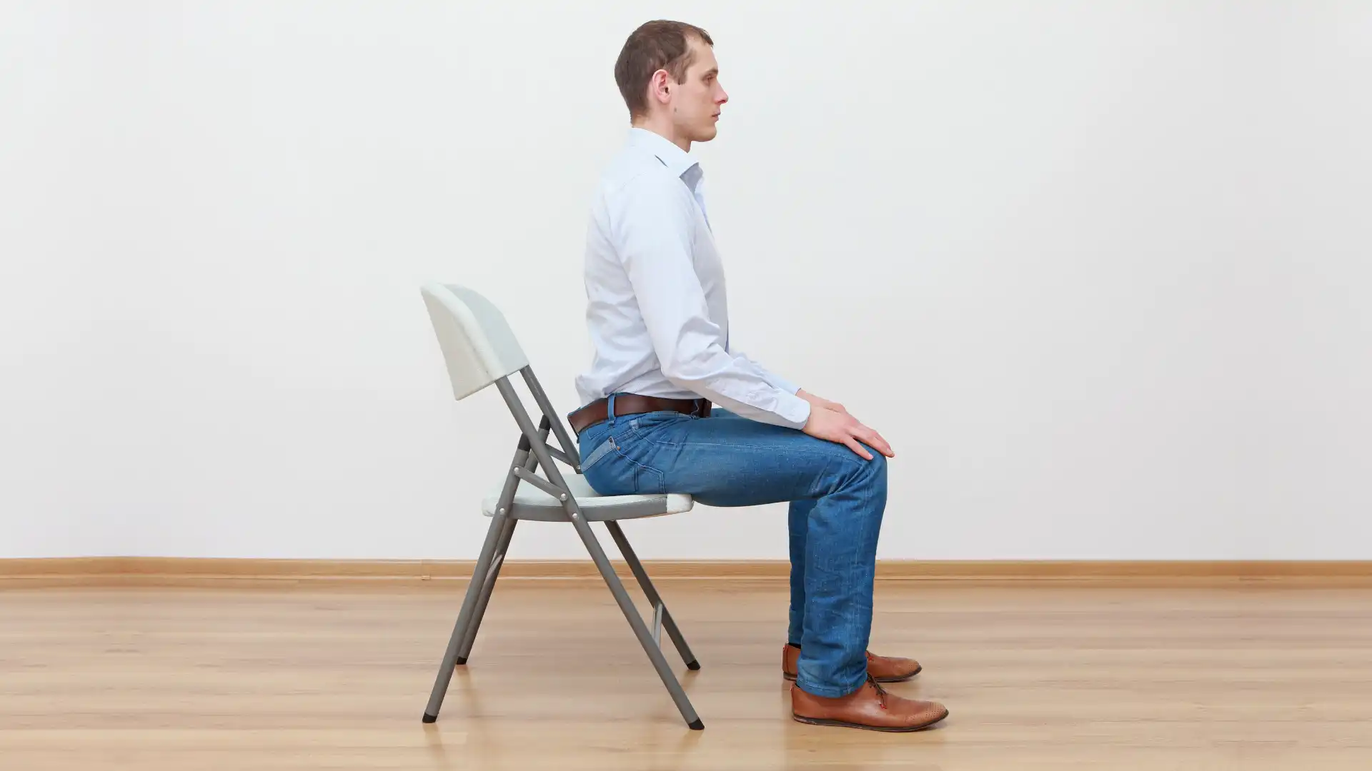 Learning how to sit in a chair properly as an example of yoga for hyperkyphosis prevention later in life