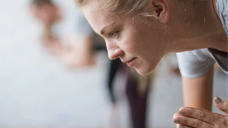 woman practicing yoga peacefully hearing empowering language