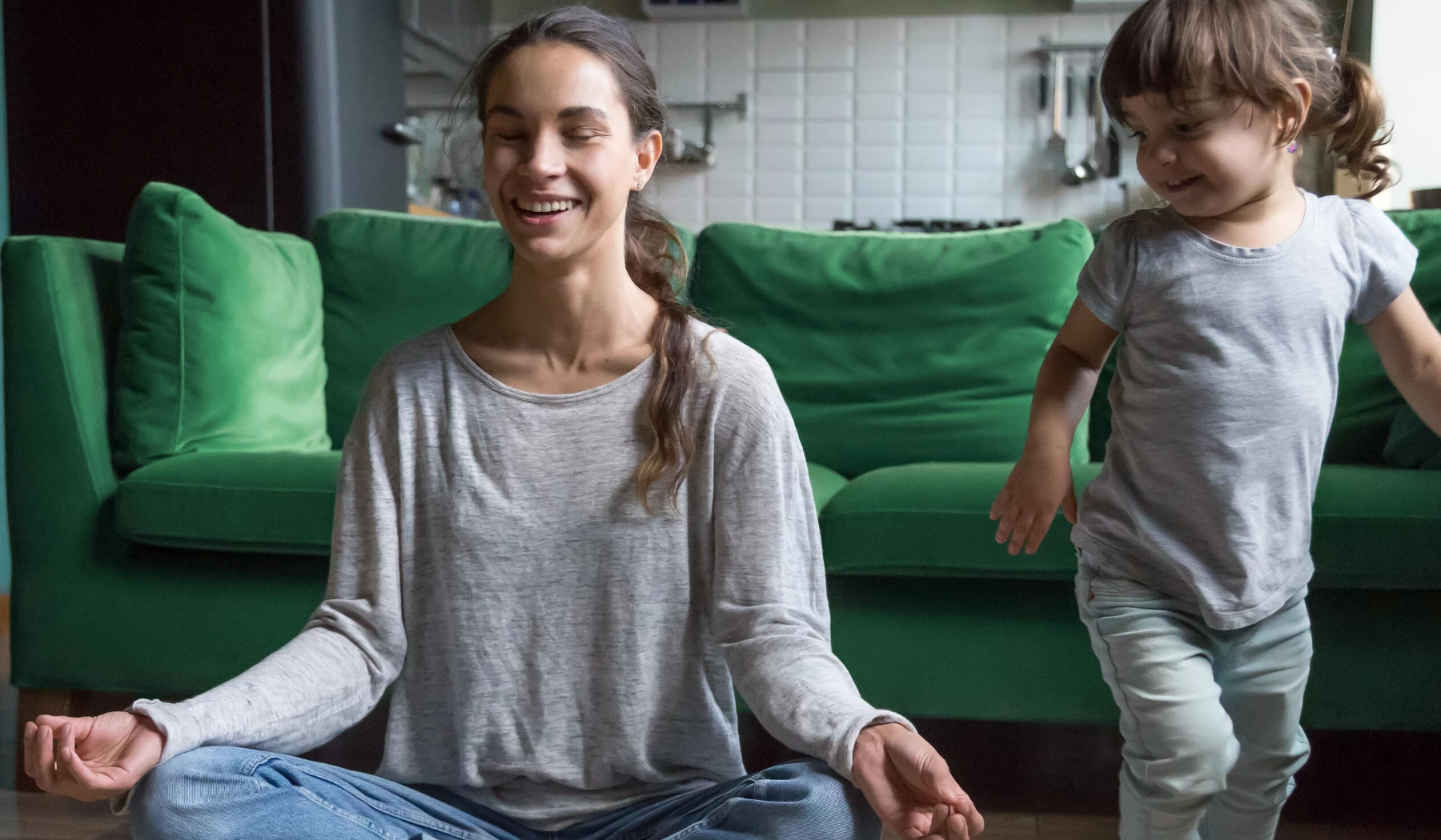 mother practicing meditation with toddler at the holidays