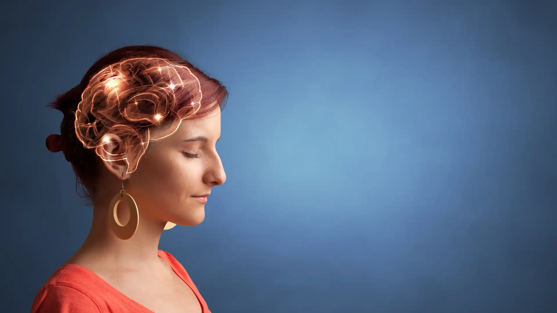 Woman meditating with her brain illuminated highlighting recent yoga research for positive effects on brain health