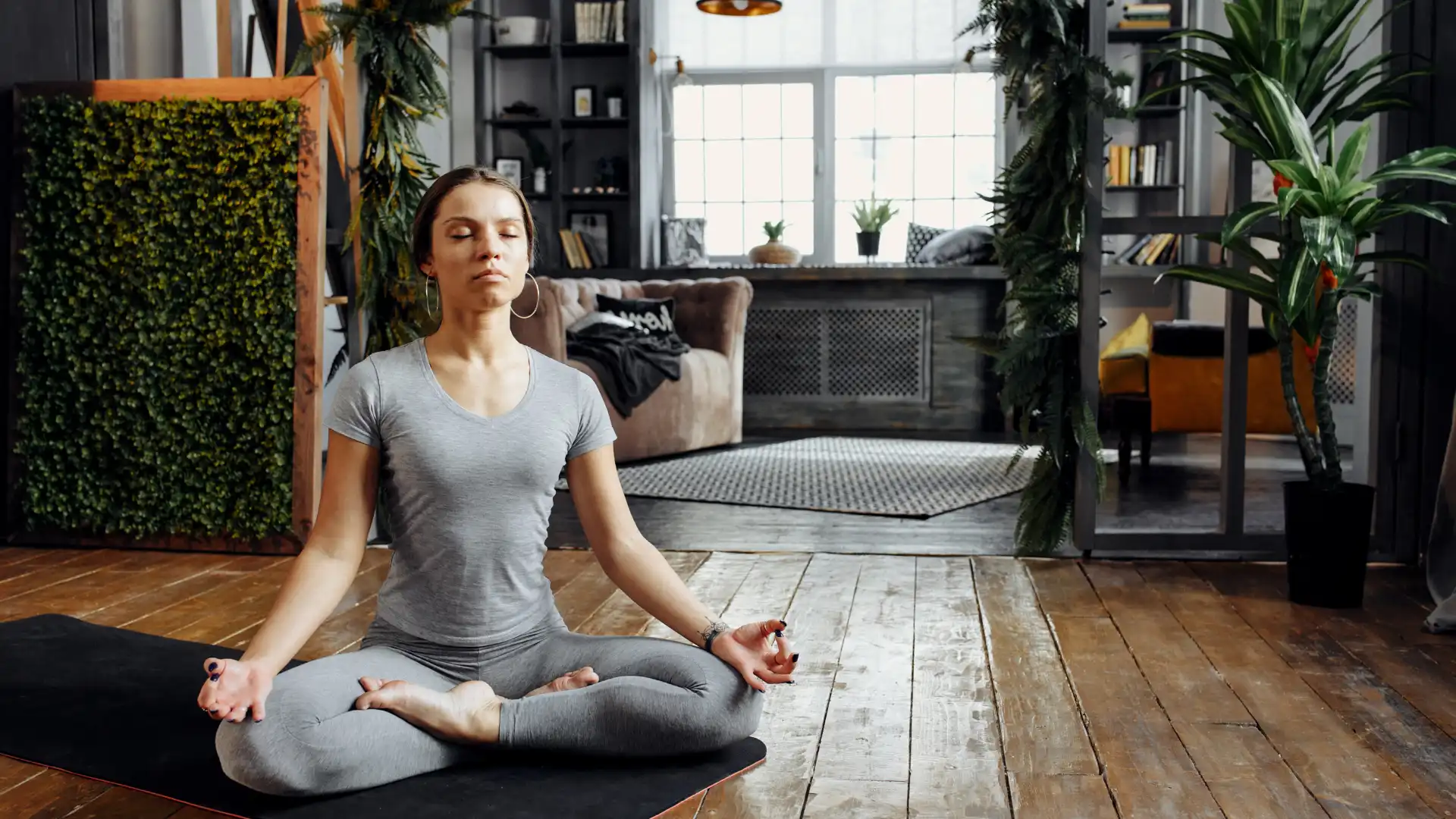 Woman practicing meditation yoga at home.