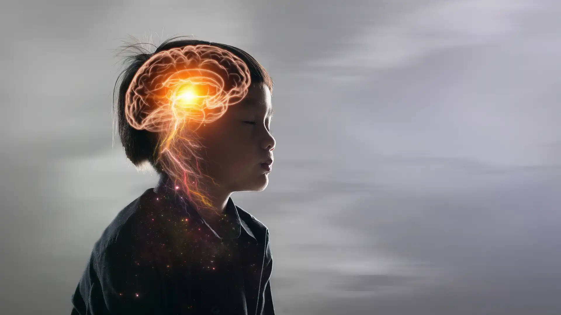 Small child seated with eyes closed - his brain and nervous system are glowing.