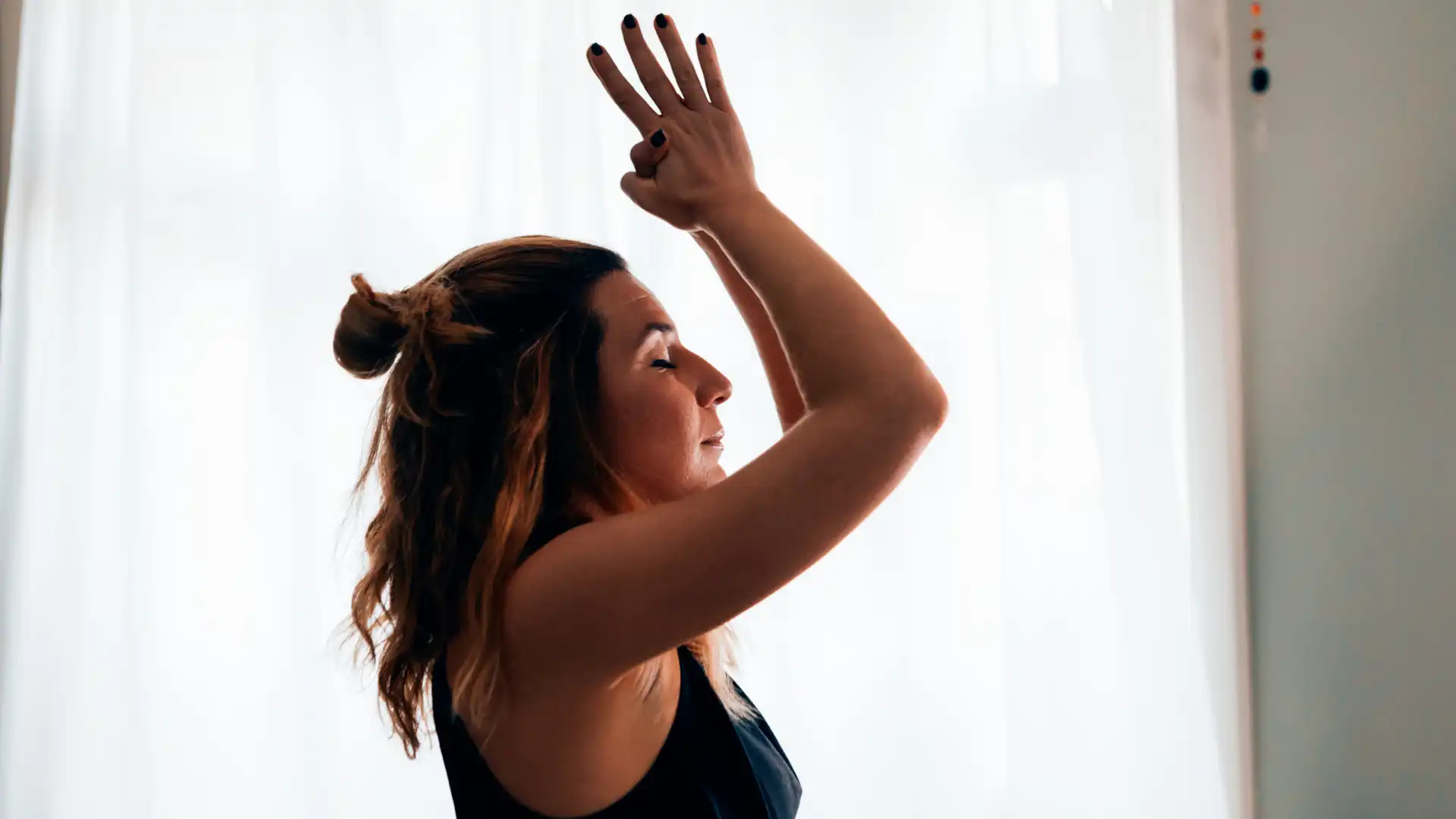 Woman practicing yoga meditation with eyes closed.