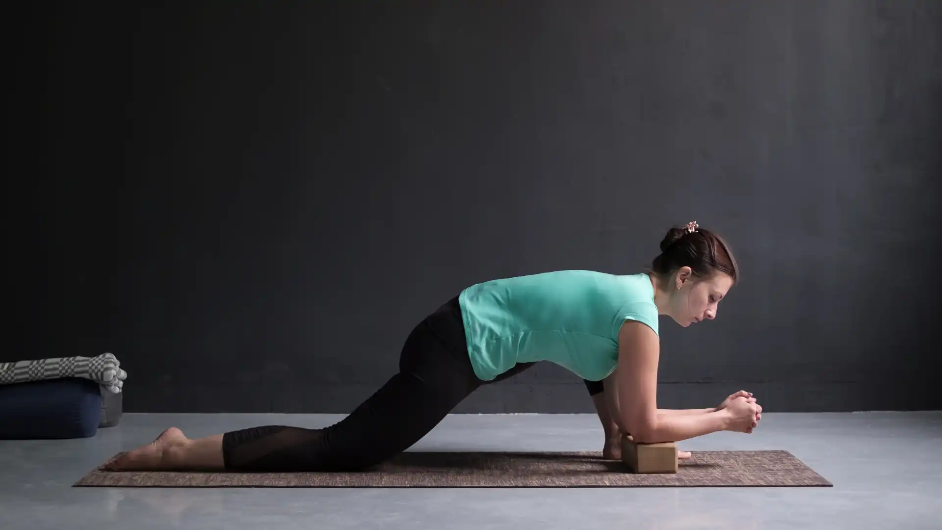 Woman practicing yoga lizard pose.