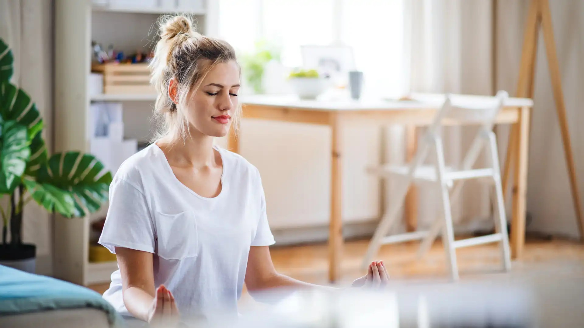 Woman practicing yoga meditation with eyes closed.