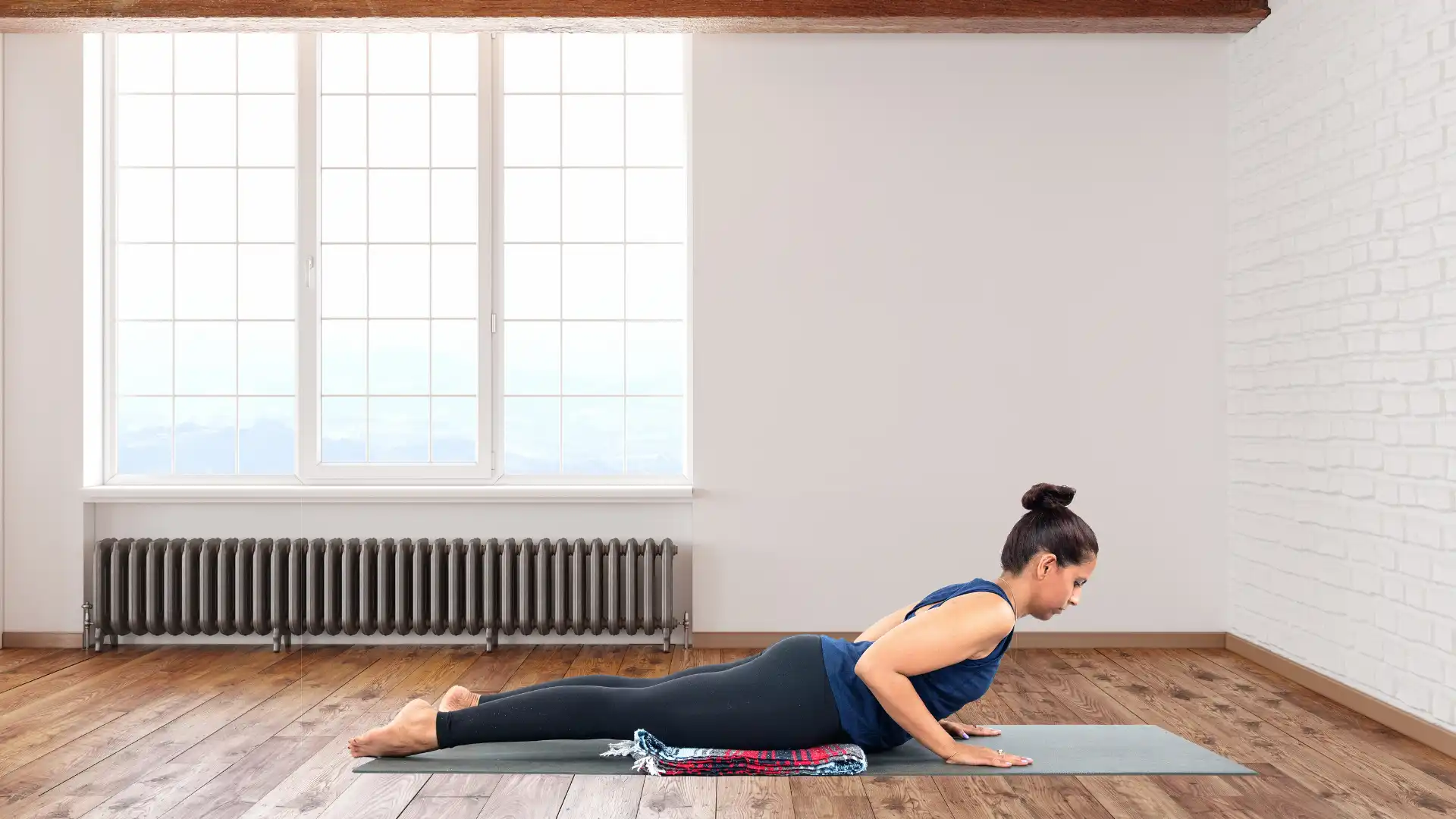 Woman practicing yoga bhujangasana cobra pose.