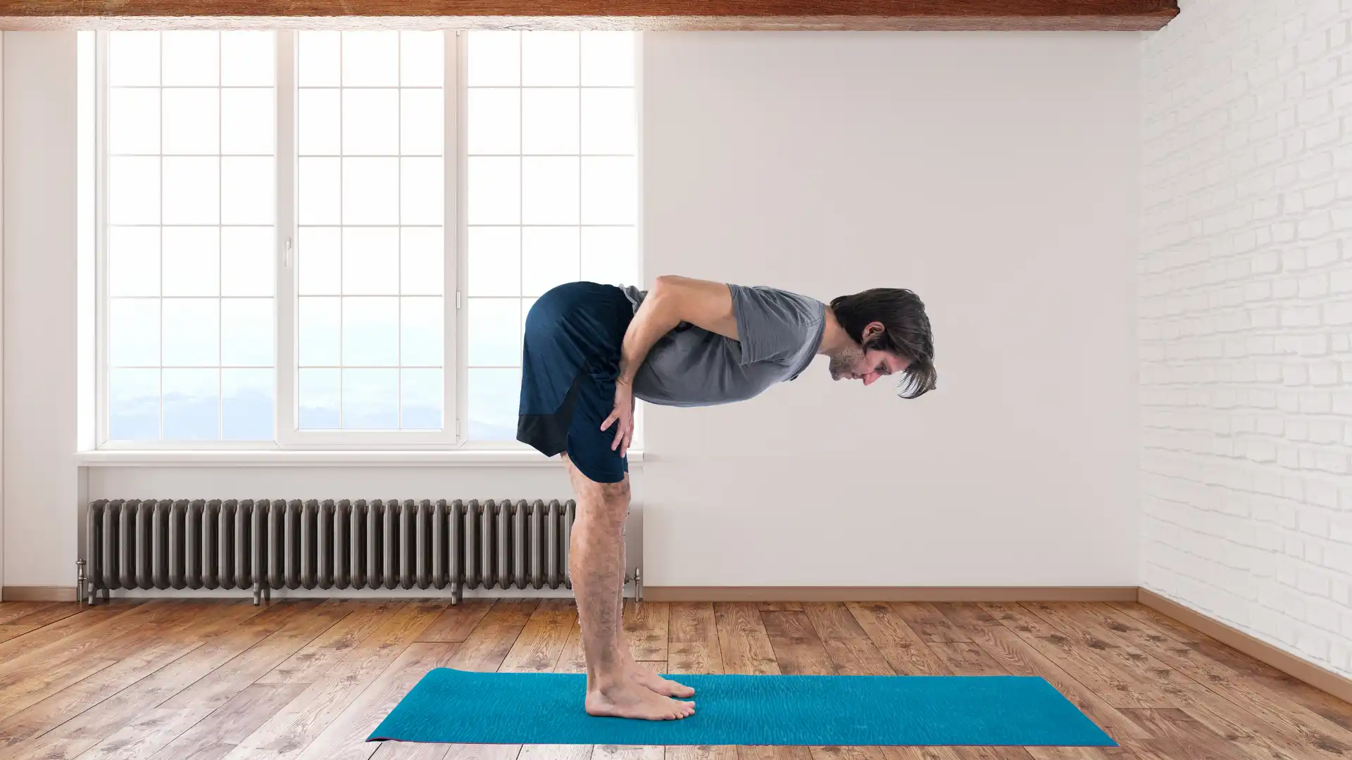 Man practicing yoga uttanasana.