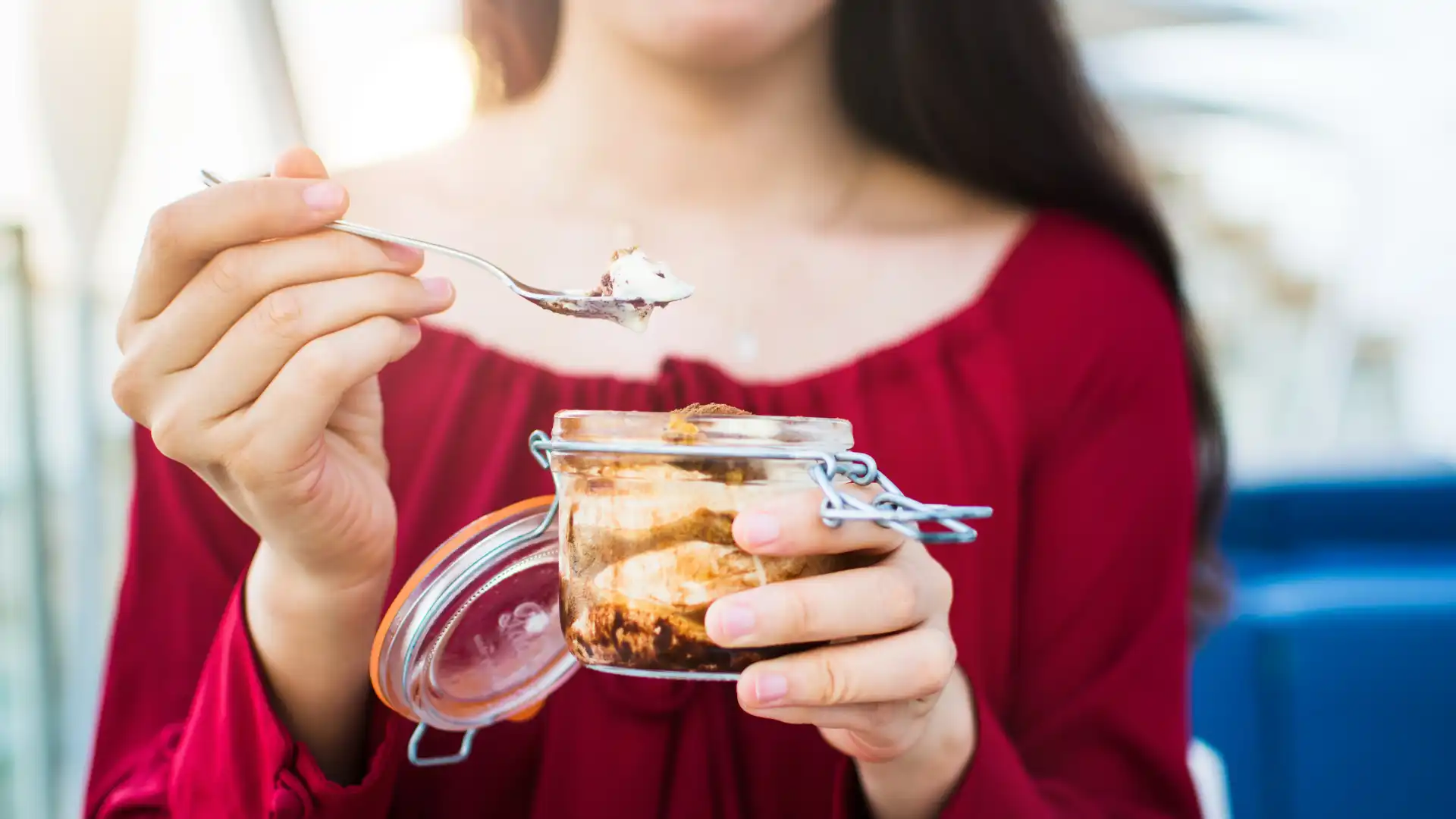 Woman eating tiramisu. 