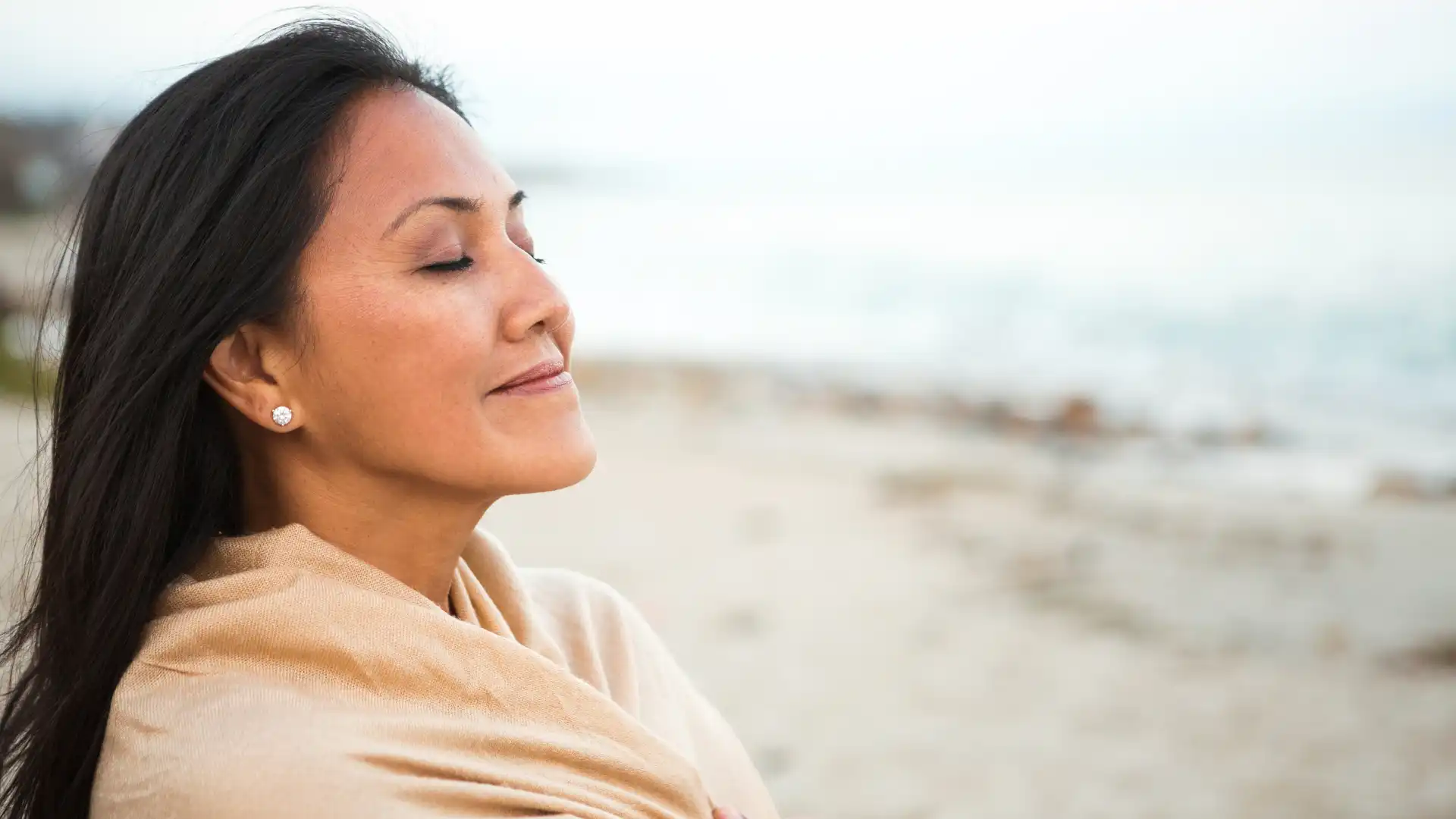 Woman smiling with eyes closed.