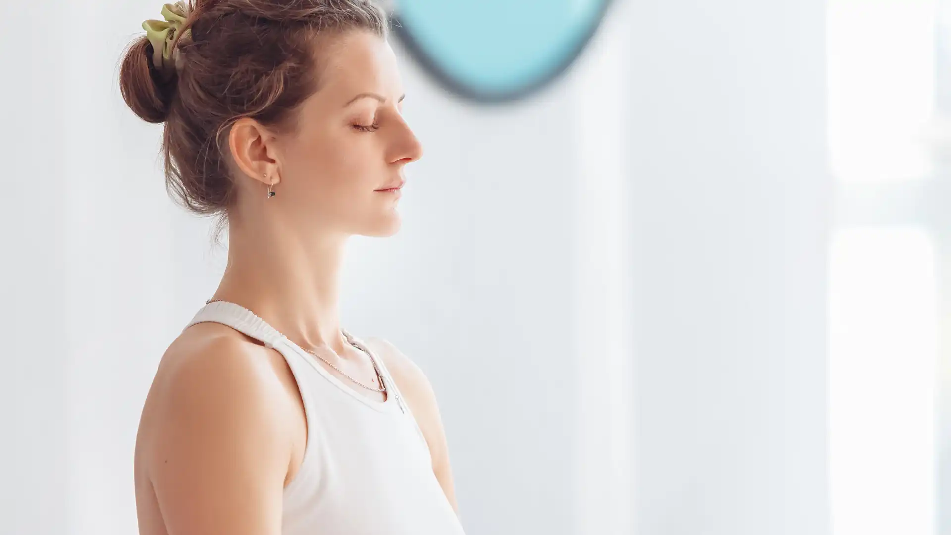 Woman practicing yoga meditation with eyes closed.