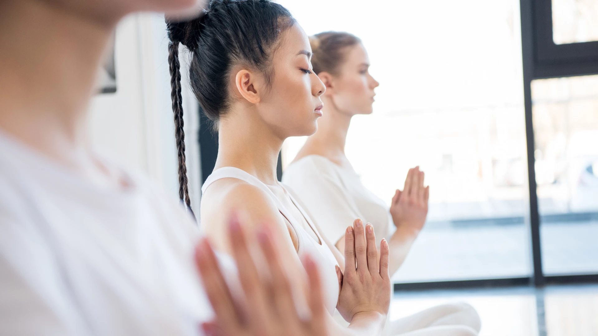 Woman practicing yoga meditation with eyes closed.