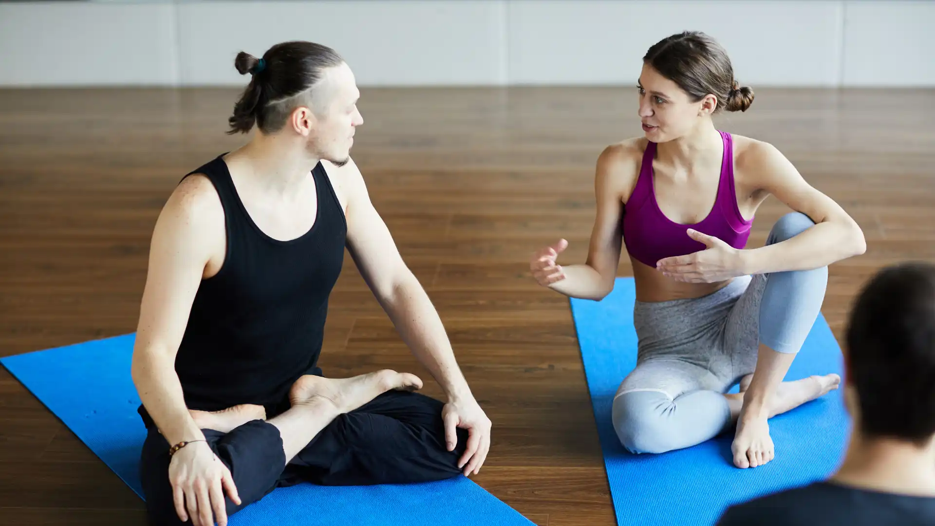 Two yoga students connecting after class..