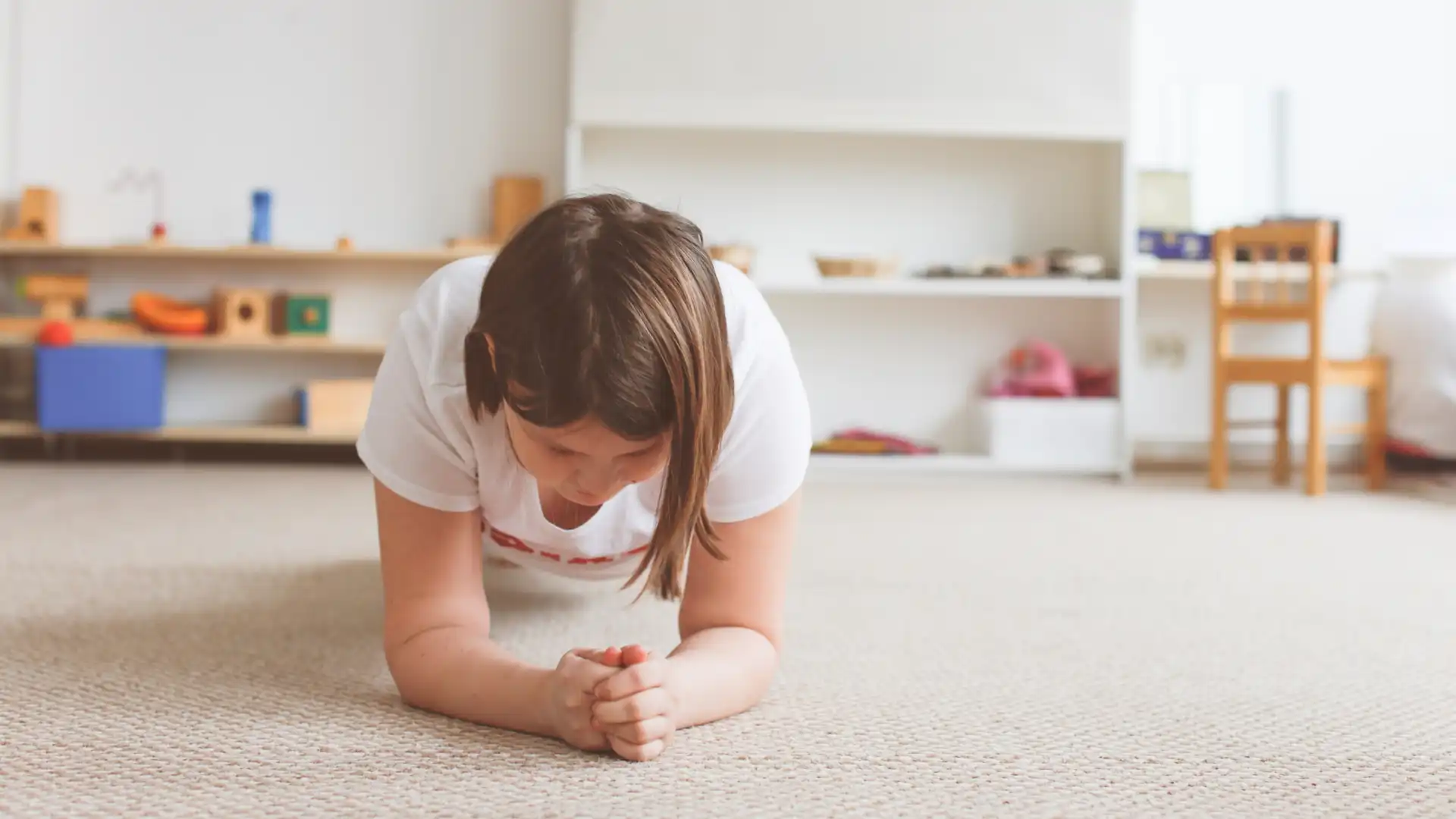 Young girl practicing yoga Plank Pose (Phalakasana)