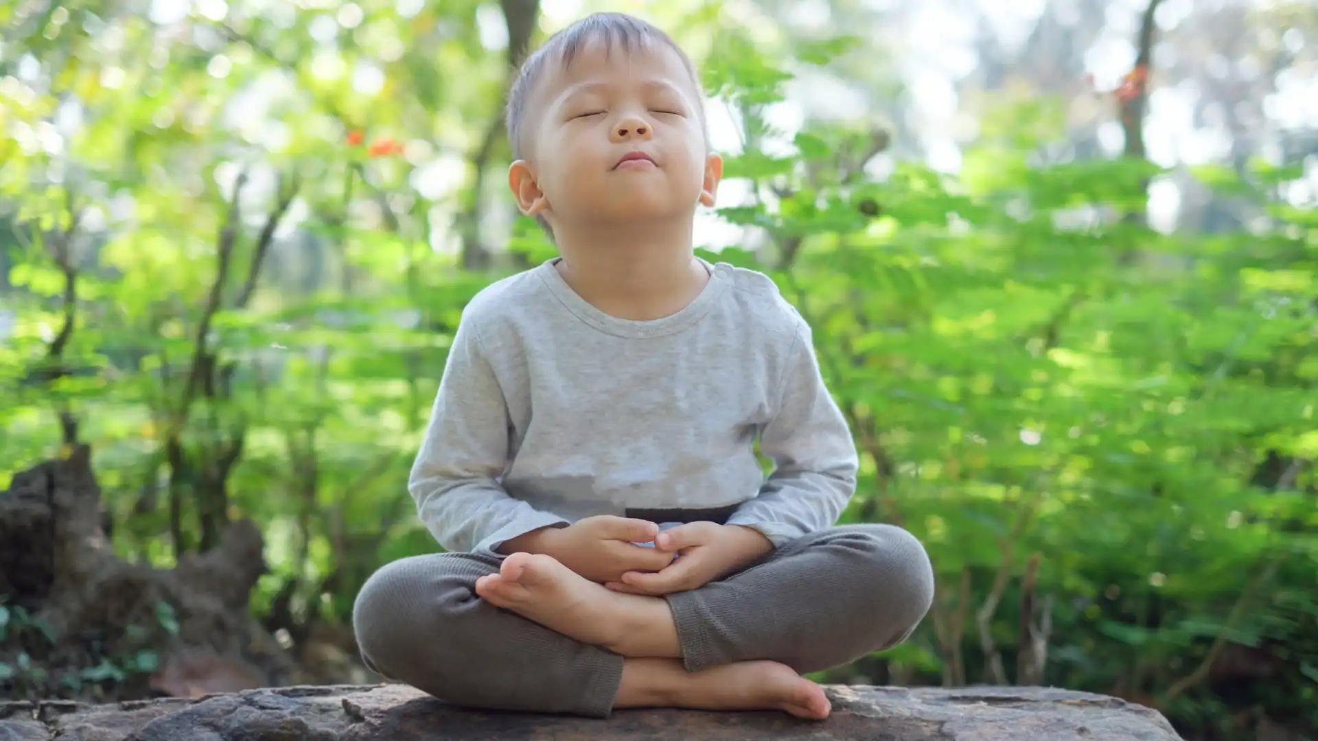 Kid practicing yoga and meditation.